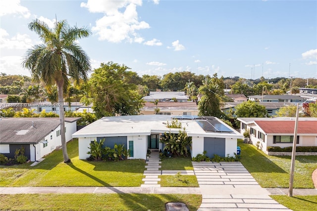 view of front of home featuring a residential view, stucco siding, and a front yard