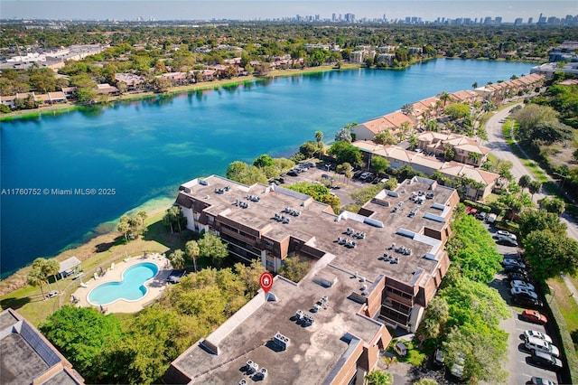 drone / aerial view featuring a view of city and a water view