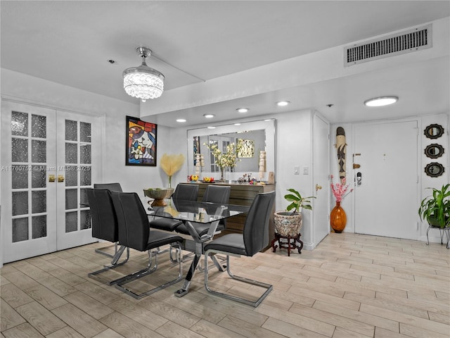 dining area featuring wood finished floors, recessed lighting, french doors, and visible vents