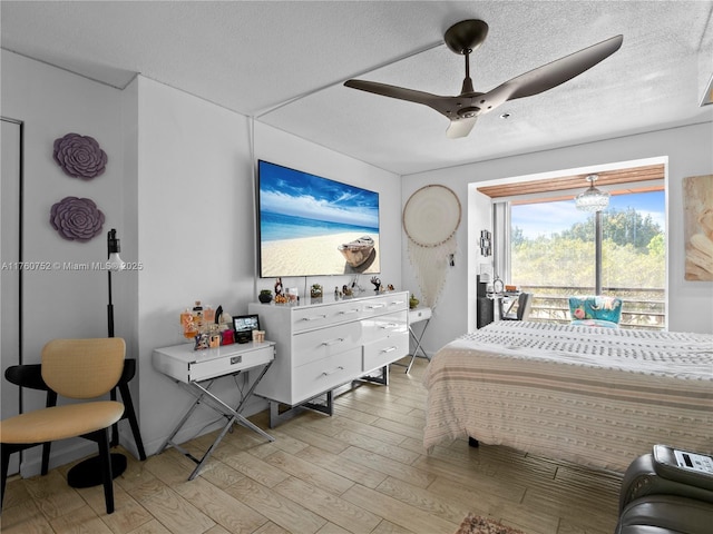 bedroom with a textured ceiling, access to outside, ceiling fan, and light wood finished floors