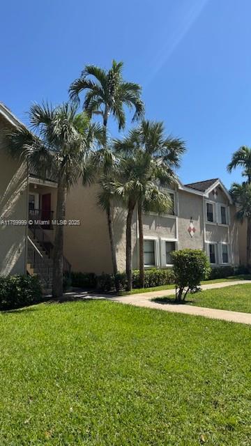 view of front of property with a front lawn and stucco siding