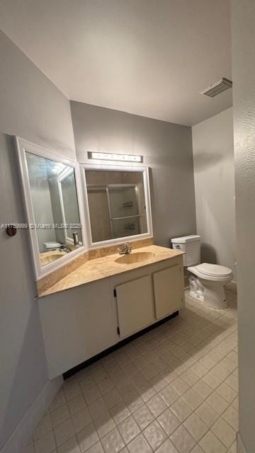 bathroom with an enclosed shower, visible vents, toilet, and vanity