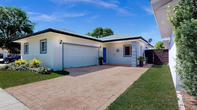 view of front of home featuring stucco siding, driveway, and an attached garage