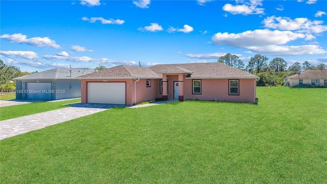 single story home featuring decorative driveway, a garage, a front yard, and stucco siding