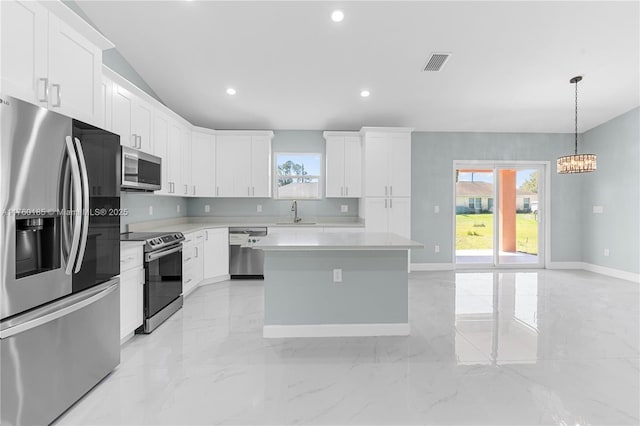 kitchen featuring visible vents, a sink, light countertops, appliances with stainless steel finishes, and marble finish floor