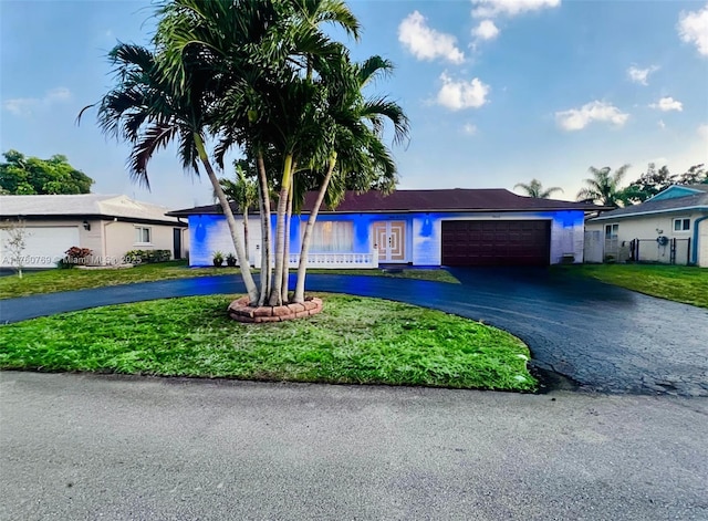 9602 NW 66th St, Tamarac, FL 33321 - ranch-style home with a front yard, a garage, fence, and curved driveway