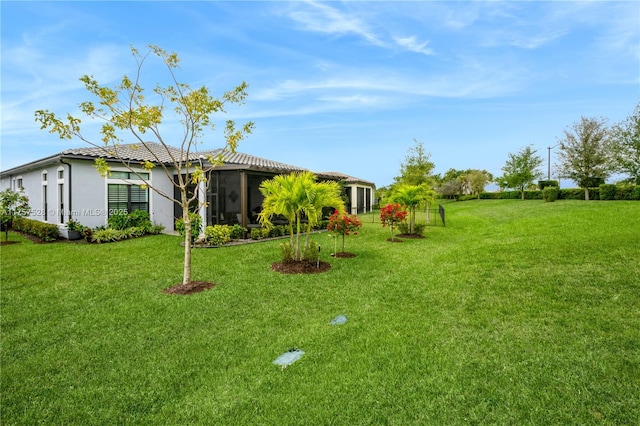 view of yard with a sunroom