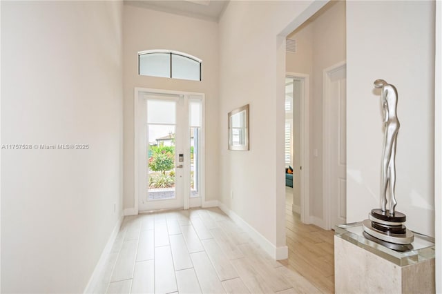 foyer featuring light wood-style floors and baseboards