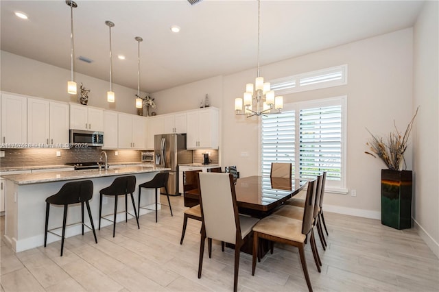 dining space with visible vents, baseboards, a chandelier, light wood-type flooring, and recessed lighting