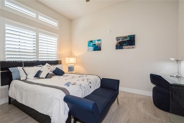 bedroom featuring baseboards and wood finished floors