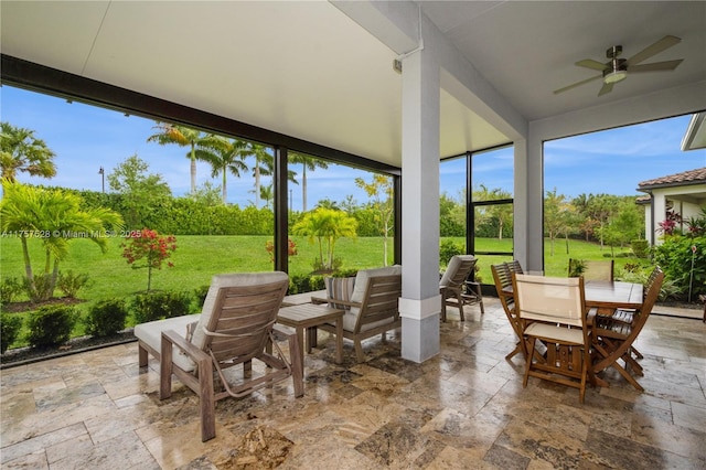 view of patio with outdoor dining area and ceiling fan