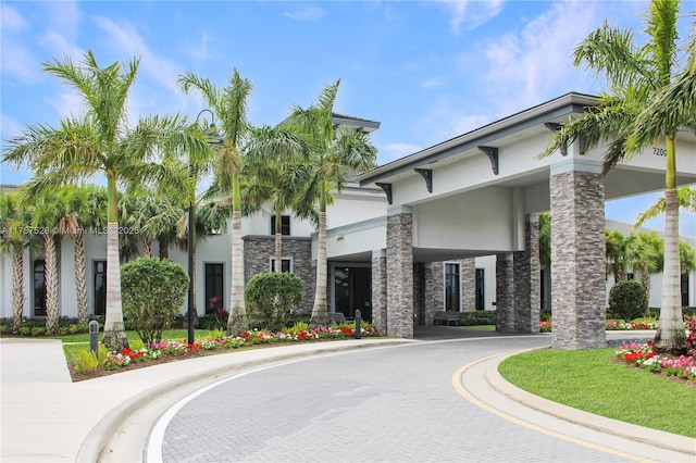 view of building exterior with curved driveway