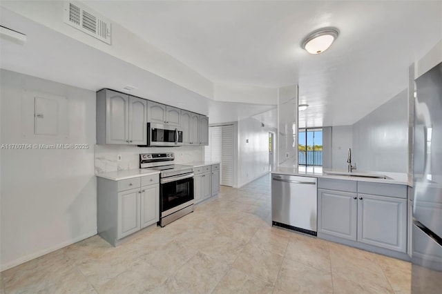 117 Lake Emerald Dr Unit 408, Oakland Park, FL 33309 - kitchen featuring stainless steel appliances, gray cabinets, a sink, light countertops, and baseboards