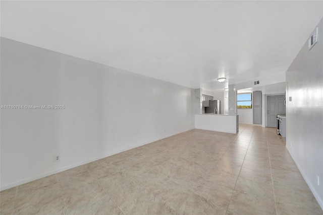 unfurnished living room with light tile patterned floors, baseboards, and visible vents