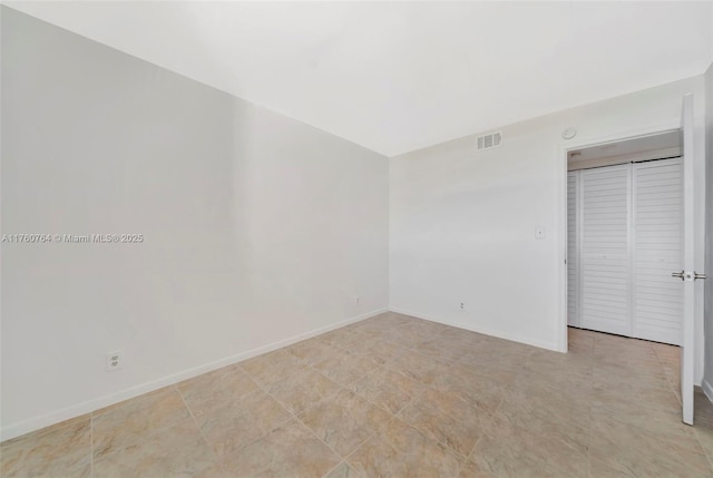 unfurnished bedroom featuring baseboards, a closet, and visible vents