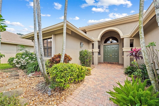 doorway to property with stucco siding