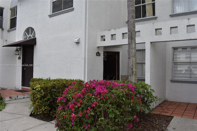 doorway to property with stucco siding