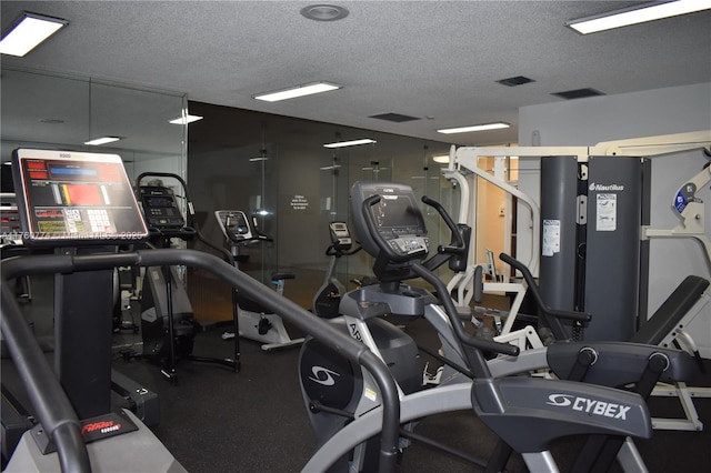 gym with visible vents and a textured ceiling