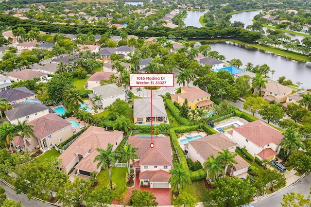 drone / aerial view featuring a residential view and a water view