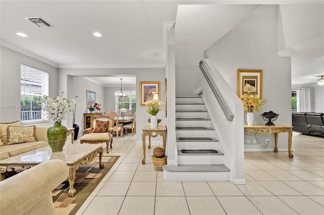 stairs with tile patterned flooring, crown molding, a notable chandelier, and visible vents