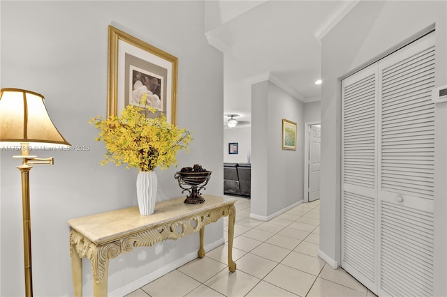 corridor featuring crown molding, light tile patterned floors, recessed lighting, and baseboards