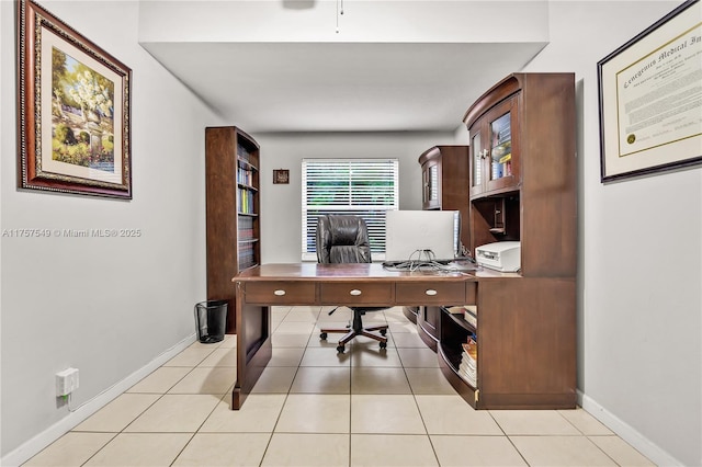 office space with light tile patterned floors and baseboards