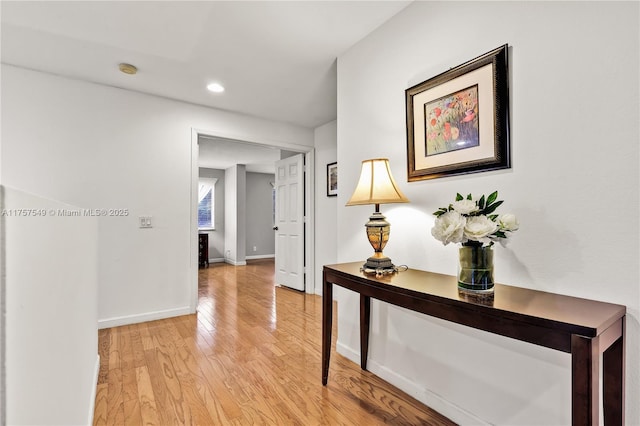 corridor featuring recessed lighting, baseboards, and light wood-style flooring