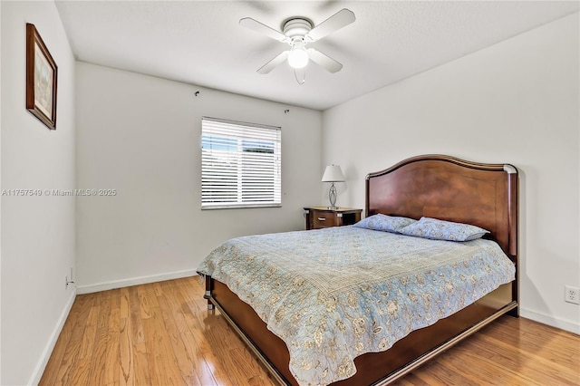 bedroom featuring wood finished floors, baseboards, and ceiling fan