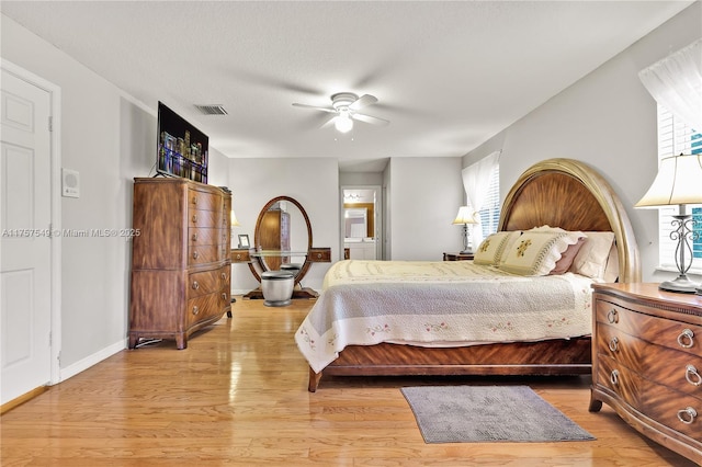 bedroom with visible vents, multiple windows, and light wood-style flooring