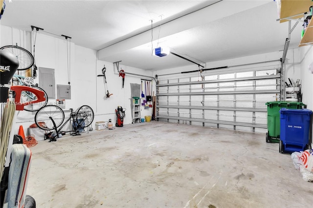 garage with electric panel and a garage door opener