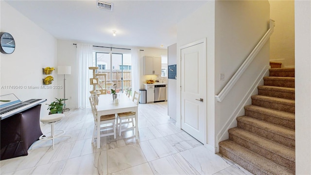 1040 SE 24th Ave, Homestead, FL 33035 - dining space with visible vents, marble finish floor, and stairs