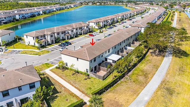 drone / aerial view with a water view and a residential view