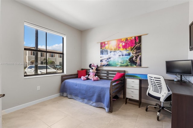 bedroom with baseboards and tile patterned floors
