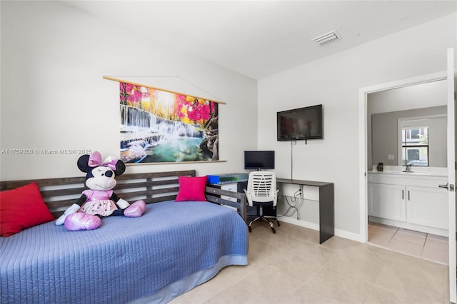 bedroom with visible vents, a sink, baseboards, and light tile patterned floors