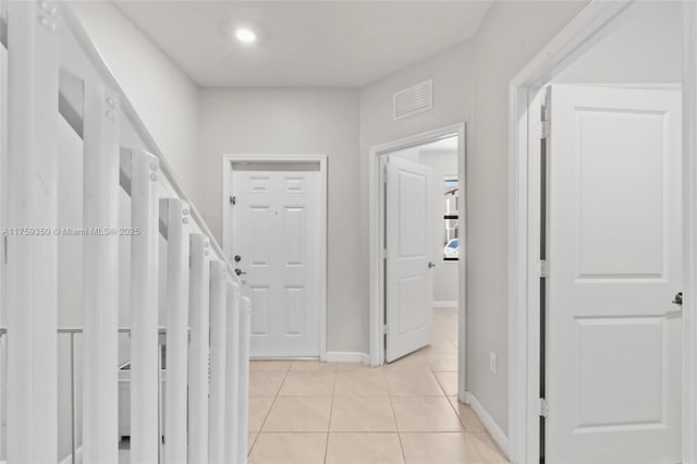 hall featuring recessed lighting, baseboards, visible vents, and light tile patterned floors