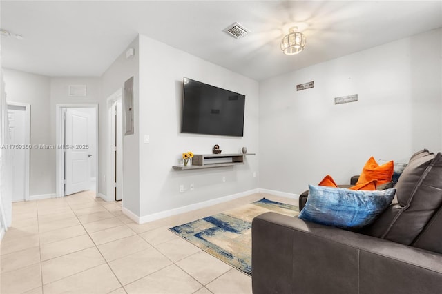 living area featuring baseboards, light tile patterned flooring, and visible vents