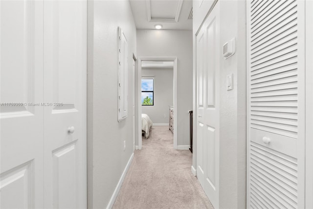 hall featuring baseboards and light carpet