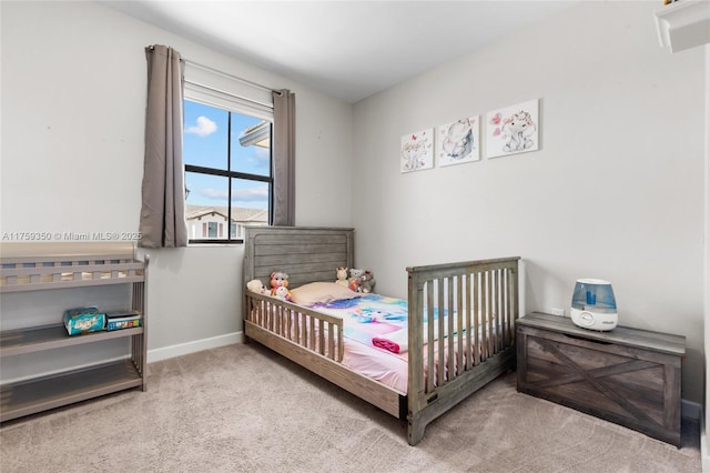 carpeted bedroom with baseboards