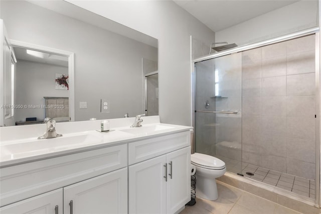 full bathroom with double vanity, a sink, and a stall shower