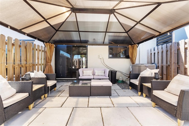 view of patio / terrace featuring a gazebo, outdoor lounge area, and fence