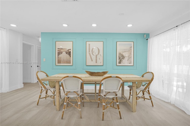 dining area with recessed lighting and wood finished floors