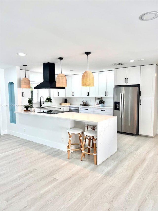kitchen featuring visible vents, light wood-style flooring, island exhaust hood, white cabinetry, and appliances with stainless steel finishes