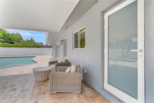view of patio with a fenced in pool and fence