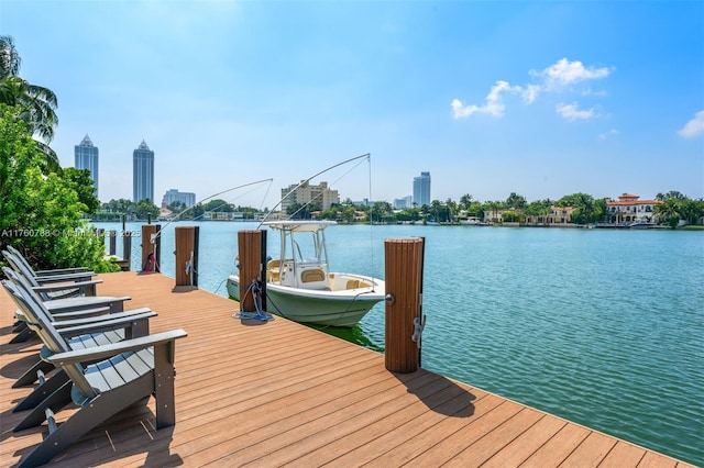 view of dock with a city view and a water view