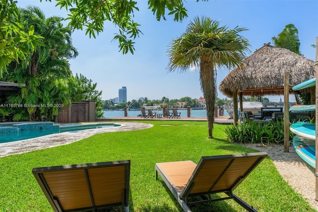 view of community with a gazebo, a yard, a water view, and a pool