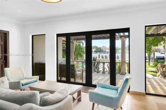 living area featuring recessed lighting, baseboards, a water view, and ornamental molding