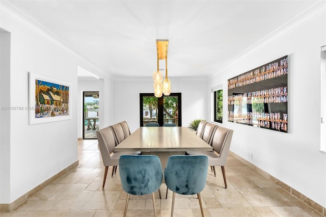 dining space with a healthy amount of sunlight, french doors, and ornamental molding