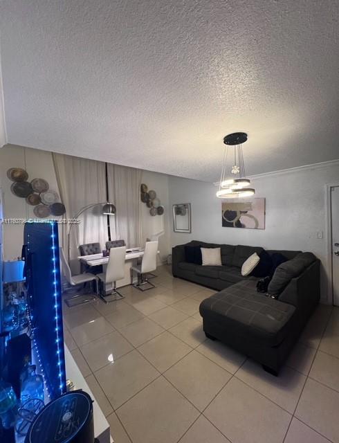 tiled living area featuring a textured ceiling