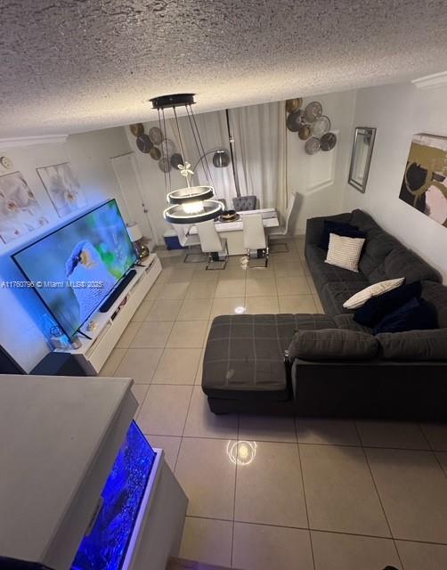 living room with tile patterned floors and a textured ceiling