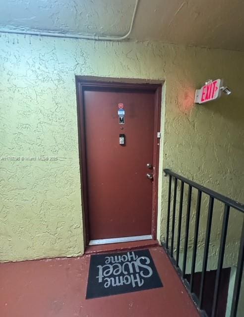 property entrance with stucco siding